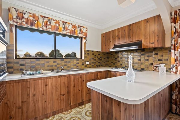 Old kitchen with dark cabinetry and mission brown tiles