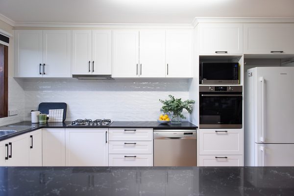 White kitchen with dark benchtops