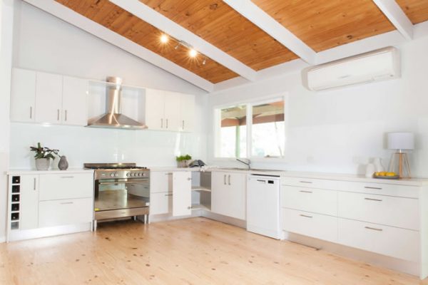 white kitchen with timber racked ceiling